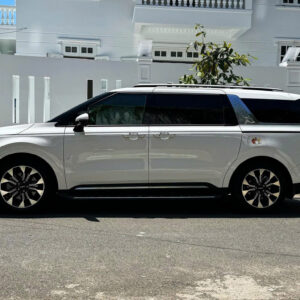 Silver minivan parked on street.